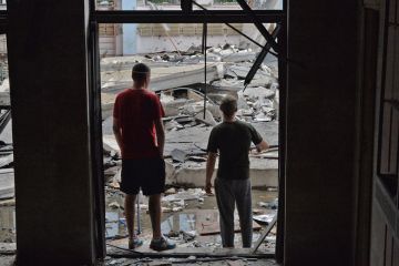 Workers inspect the damage after a Russian missile hits the National Technical University in Kharkiv, Ukraine to illustrate Ukrainian staff report high anxiety and little institutional help