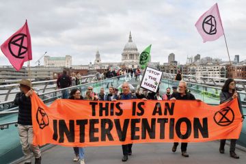 Climate activists from the Extinction Rebellion group cross the Millennium bridge as a metaphor for How I became a climate activist
