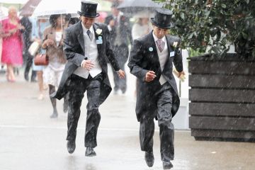 Racegoers run for cover during a torrential rain to illustrate Golden triangle research ‘no more golden than rest of UK