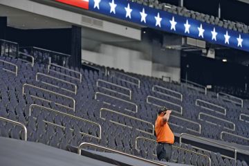 A security guard salutes while standing among empty seatsin Las Vegas, Nevada A security guard salutes while standing among empty seatsin Las Vegas, Nevada to illustrate US universities fear ‘ghosting’ by international students