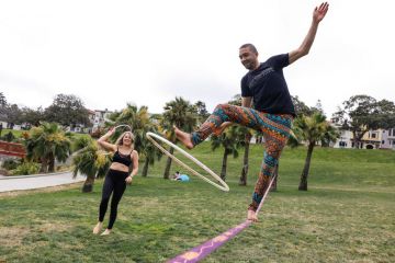 Person holding a hula hoop on a  tightrope practicing his skills to illustrate Want to improve students’ grades? Teach them life coping skills