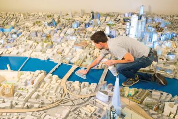 Person cleans the City of London's official 1:500th scale architectural model of central London to illustrate Is a federated model universities’ future? 