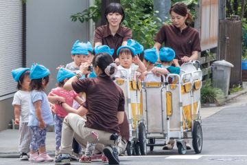 Japanese nursery babies in an outing at Kamimeguro street, Tokyo, Japan. Japanese nursery babies in an outing at Kamimeguro street, Tokyo, Japan to illustrate Tokyo axes tuition fees for large families to boost universities