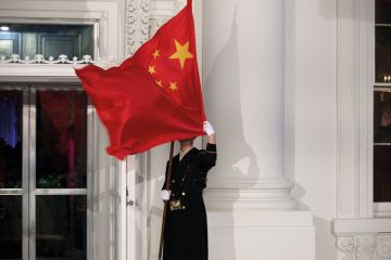 A military honor guard holds the Chinese flag in front of the White House in Washington which has blown over his face A military honor guard holds the Chinese flag in front of the White House in Washington which has blown over his face to illustrate Republicans target universities over China and political research
