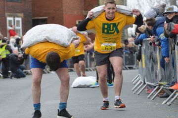 Competitors take part in the World Coal Carrying Championships in Gawthorpe, West Yorkshire. Competitors take part in the World Coal Carrying Championships in Gawthorpe, West Yorkshire to illustrate Staff and students bowed by workloads