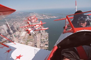 A group of pilots fly over Toronto Group of pilots fly over Toronto to illustrate Canada wants foreign students to access all areas across the country