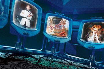 Three screen monitors with James Bond, Cake baking and Freddie Mercury singing.