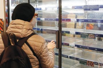 Person looking at empty shelves in a supermarket as a metaphor for Supply shortages snarl US laboratories
