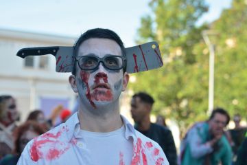 Bristol Zombie walk, man with fake axe over his head Bristol Zombie walk, man with fake axe over his head to illustrate Universities alarmed as ‘bloody’ budget set to hike staff costs