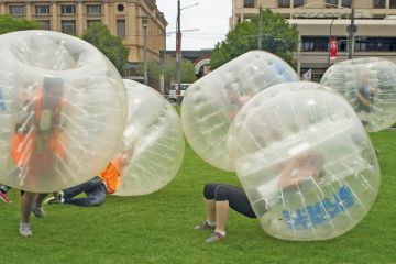 People enjoy playing bubble soccer in Adelaide Australia to illustrate Australian HE must see that geopolitics underpins caps, says policy analyst