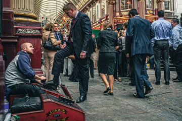 Shoe cleaner is polishing the shoes of a buissnesman in Leadenhall Market Shoe cleaner is polishing the shoes of a buissnesman in Leadenhall Market to illustrate Academics ‘treat staff like scum’