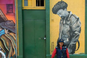 Woman standing in front of door, Santiago, Santiago Metropolitan Region, Chile
