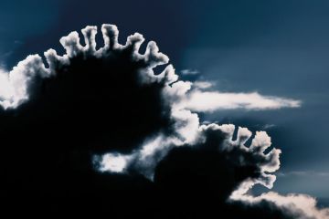 Sunlight shining through black cloud creating silver lining, East Yorkshire, UK Sunlight shining through black cloud creating silver lining, East Yorkshire, UK