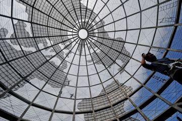 Workers are silhouetted as they replace broken LED lights on a huge bronze globe in front of a mall in Manila Workers are silhouetted as they replace broken LED lights on a huge bronze globe in front of a mall in Manila to illustrate Internationalisation professionals have mixed feelings on leaders