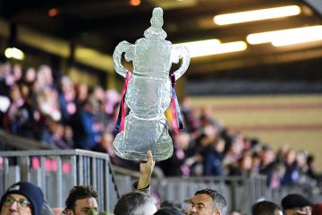 A foil replica FA Cup is held up high at Champion Hill in London to illustrate Degree apprenticeships: ‘don’t ruin something world is adopting’
