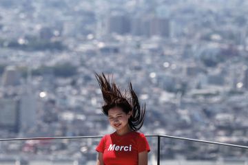 A woman poses for a picture with her hair blown upwards with the Tokyo skyline on the Shibuya Sky observation deck in Tokyo A woman poses for a picture with her hair blown upwards with the Tokyo skyline on the Shibuya Sky observation deck in Tokyo to illustrate ‘Sharp rise’ in science gender quotas at Japanese universities