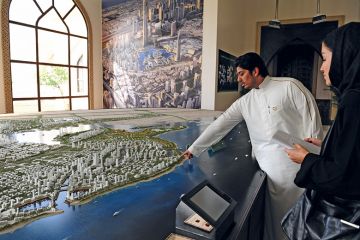 Person shows the architecural model of King Abdullah Economic City in Jeddah
