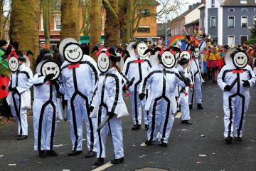 Group of people in same costume wearing same smiling mask as a metaphor for a tool using facial and keystroke recognition has been launched.