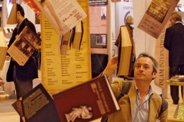 A man reads a book hanging at Earls Court Exhibition Centre in London_alamy.jpg A man reads a book hanging at Earls Court Exhibition Centre in London to illustrate Don’t wait to tackle open access books cash challenge, REF told