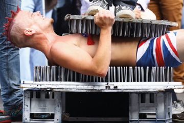 A Street entertainer lays down on a bed of nails A Street entertainer lays down on a bed of nails to illustrate Next generation of humanities scholars ‘imperilled’ by PhD cuts