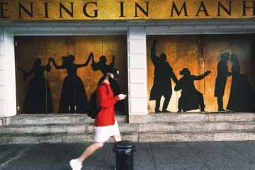 Broadway theaters stand closed along an empty street in the theater district Broadway theaters stand closed along an empty street in the theater district