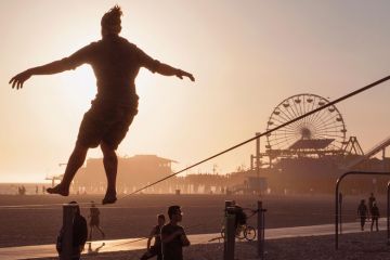 Tight rope practice on beach near the Santa Monica Pier, Los Angeles to illustrate UC plan to hire undocumented students ‘cautiously progressing’