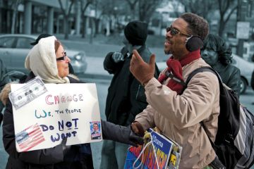 Two people having a disagreement over policies outside of the Renaissance Harborplace Hotel in Baltimore Two people having a disagreement over policies outside of the Renaissance Harborplace Hotel in Baltimore to illustrate If we are to disagree well, we must learn to balance humility and conviction