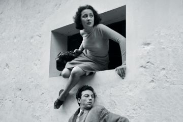 Woman escaping through a window, France, 1935 Woman escaping through a window, France, 1935