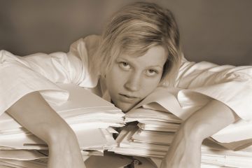 Woman exhausted on papers Woman exhausted on papers