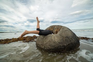 Woman falling into rock on beach