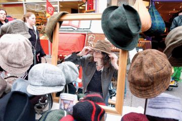 Woman tries on hats Woman tries on hats