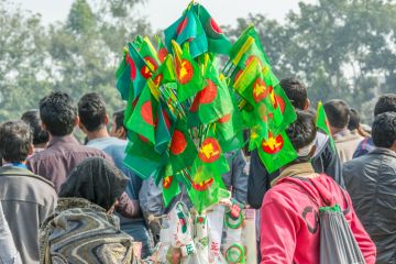 woman buying national flag of Bangladesh to celebration of Bangladesh Independence and National Day at Madhupur, Tangail