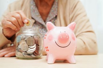 woman counting coins money with piggy bank