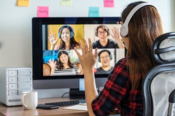 woman say hello with teamwork colleague in video conference when Coronavirus outbreak