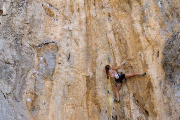 Woman sport climbing in Kalymnos island