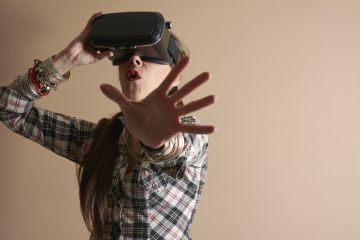 Woman using virtual reality headset Woman using virtual reality headset