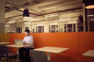 Man working on laptop alone Man working on laptop alone