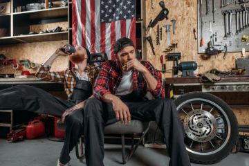 Depressed mechanics in the US, in front of an American flag