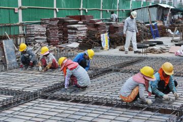 Workmen working on building foundations