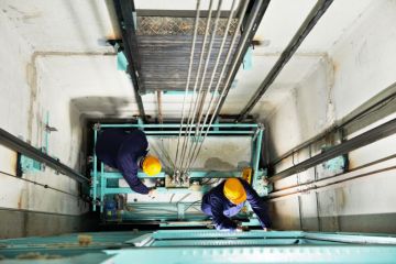 Workmen repairing a lift