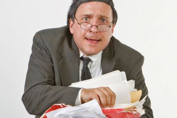 Worried businessman carrying paperwork