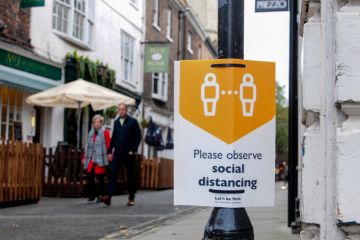Advisory sign on lamp post York, UK, England, 24-10-2020, Advisory sign on lamp post in the city Centre advising people observe the social distancing guidelines