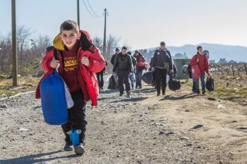 Young boy leads caravan of Syrian refugees