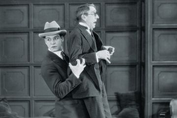 Young man picking up and carrying older man Young man picking up and carrying older man