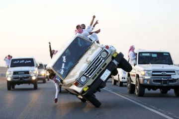 Young men driving on two wheels Young men driving on two wheels