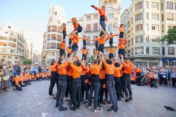 Young members of moixiganga group forming human tower on the street festival in Valencia Young members of moixiganga group forming human tower on the street festival in Valencia