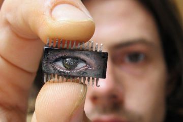 Yuri Zupancic holding microchip painting Yuri Zupancic holding microchip painting