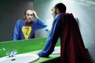 Balding superhero checking hair in mirror Balding superhero checking hair in mirror