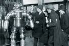 Men examining 1950s-style robot Men examining 1950s-style robot