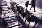 People walk past second hand books for sale People walk past second hand books for sale